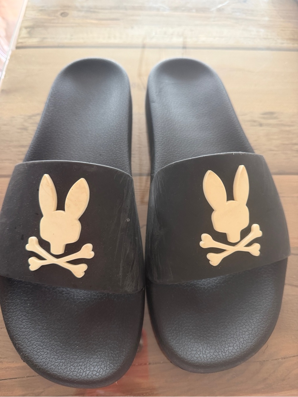 Psycho Bunny Black Slides with Cream Skull-and-Crossbones Logo